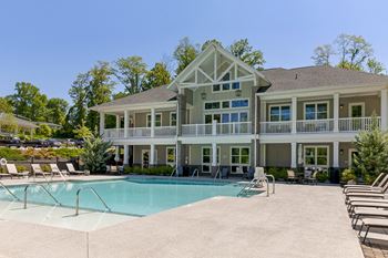 A large house with a pool in front.